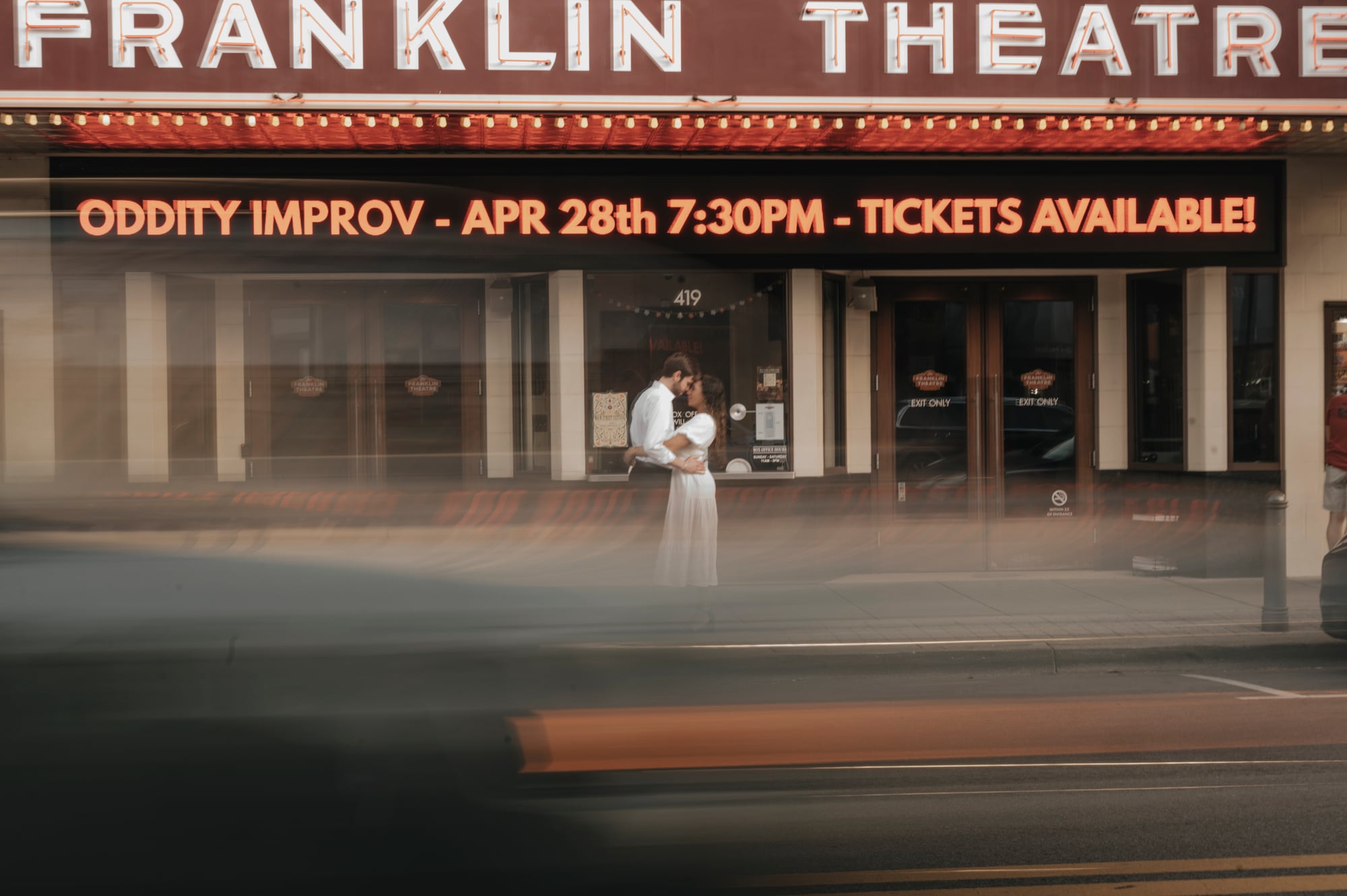 Couple embracing in front of the Franklin Theatre