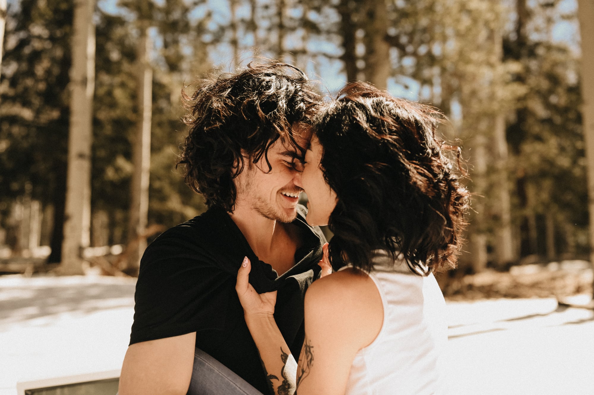 Close portrait of a couple smiling with foreheads nearly touching