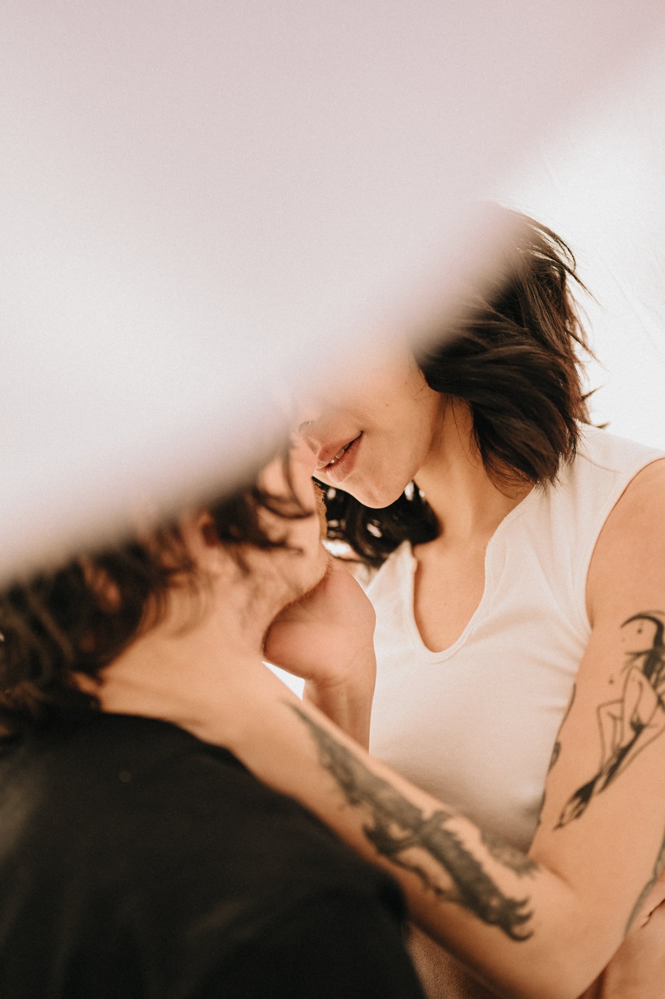 Intimate close-up of a couple in soft natural light among the trees