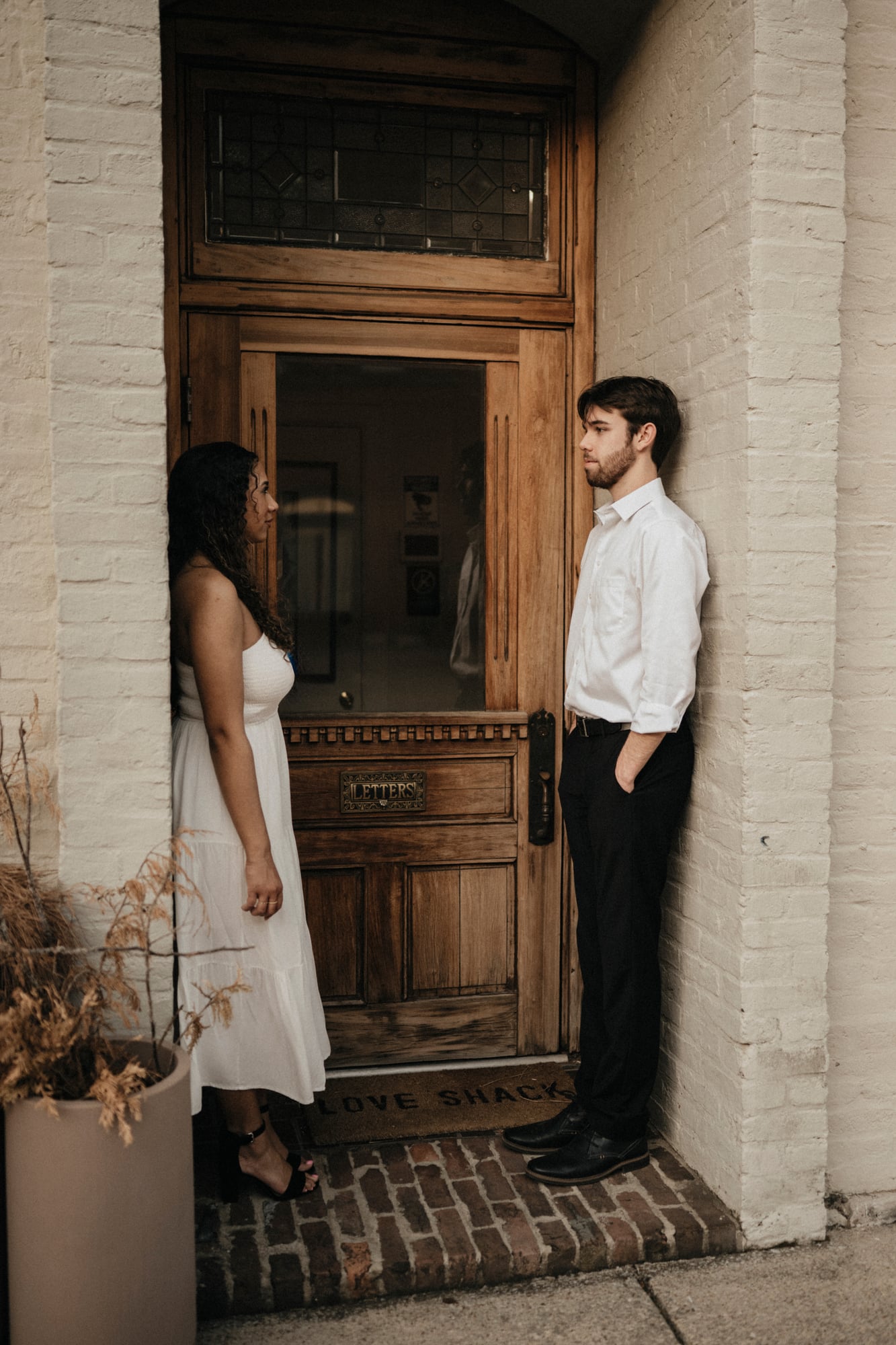 Couple standing together in a brick doorway on a historic Franklin street