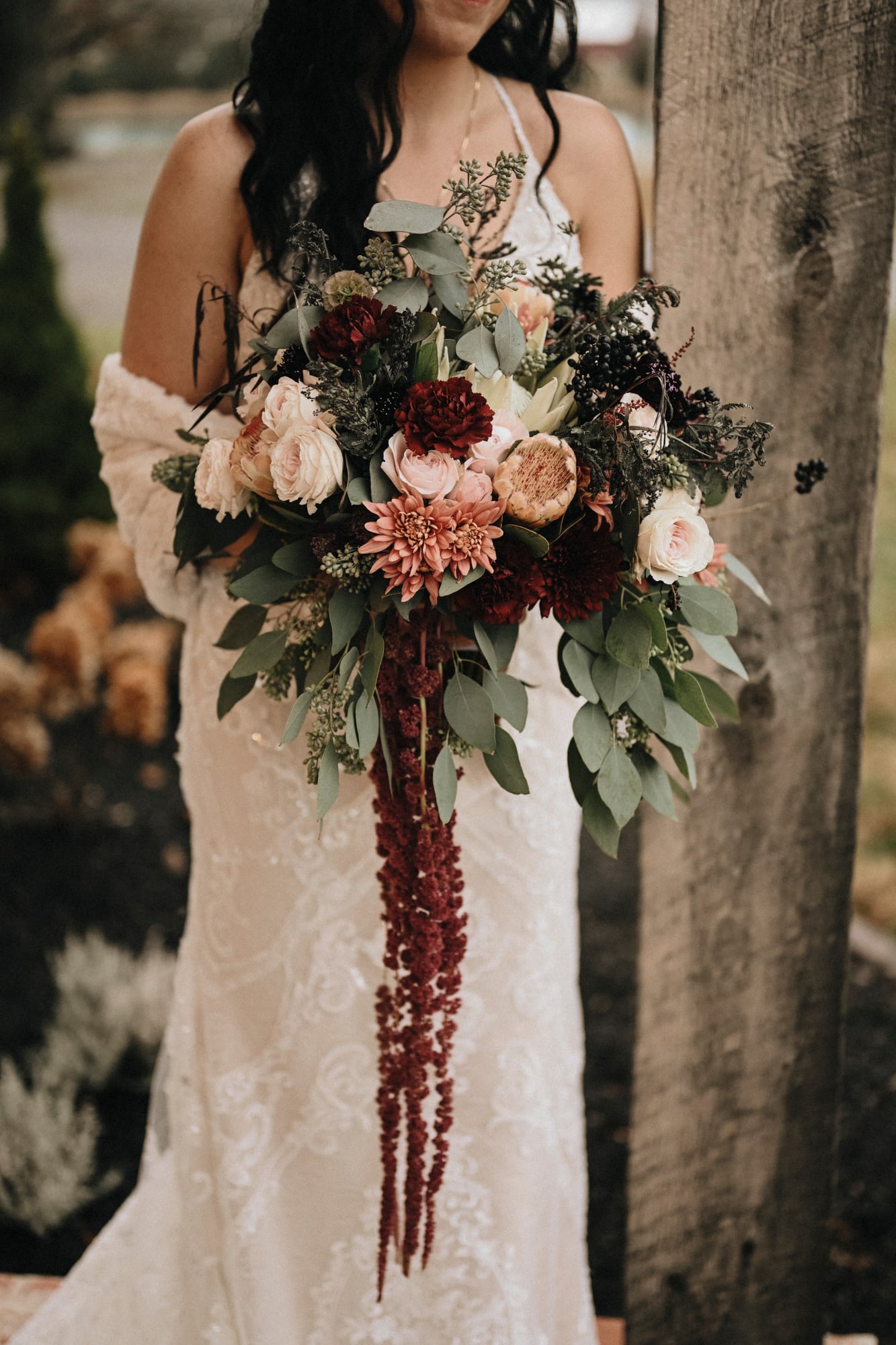 Close detail of a cascading burgundy and blush bridal bouquet