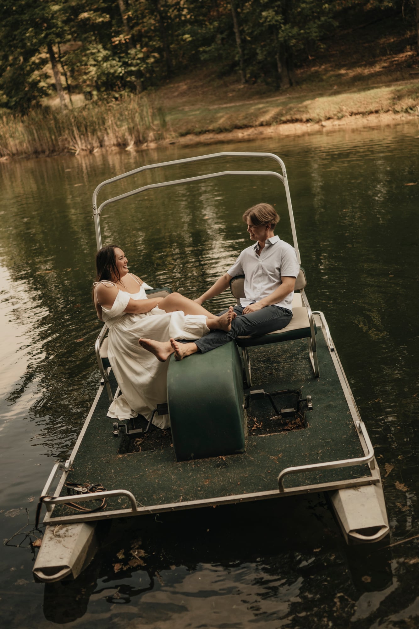 Couple laughing together outdoors by the lake