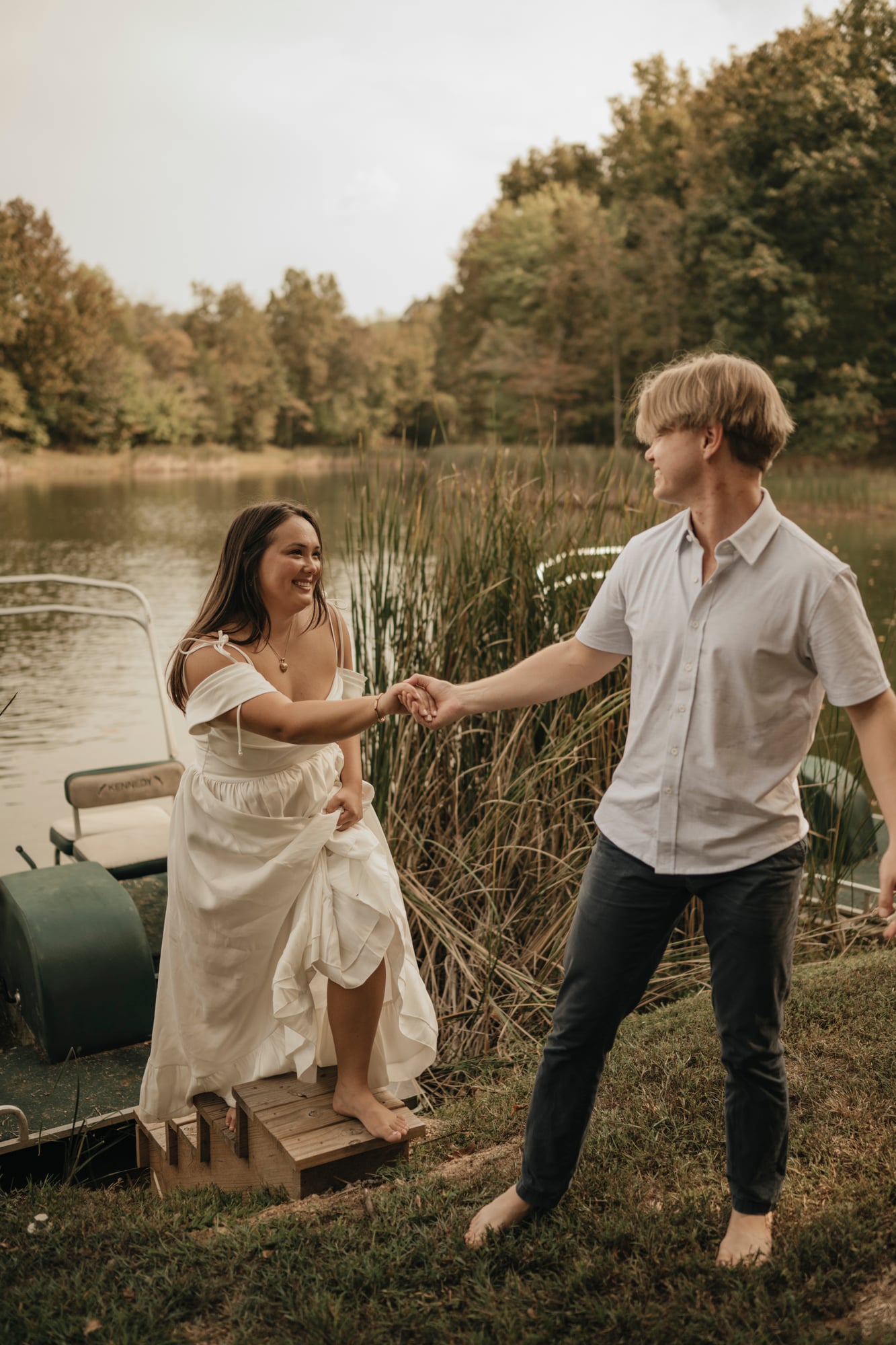 Couple at the lake shore stepping off a paddle boat