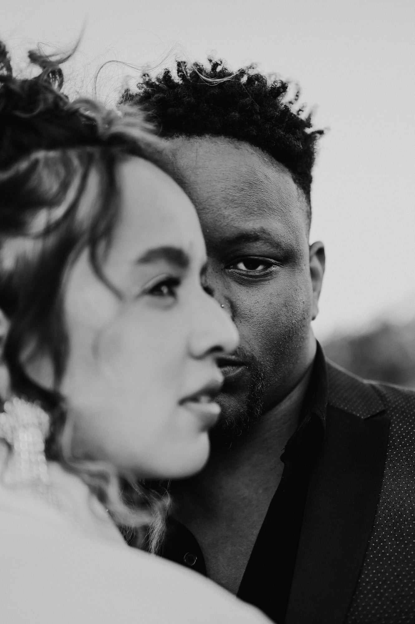 Black and white portrait of a couple cheek to cheek