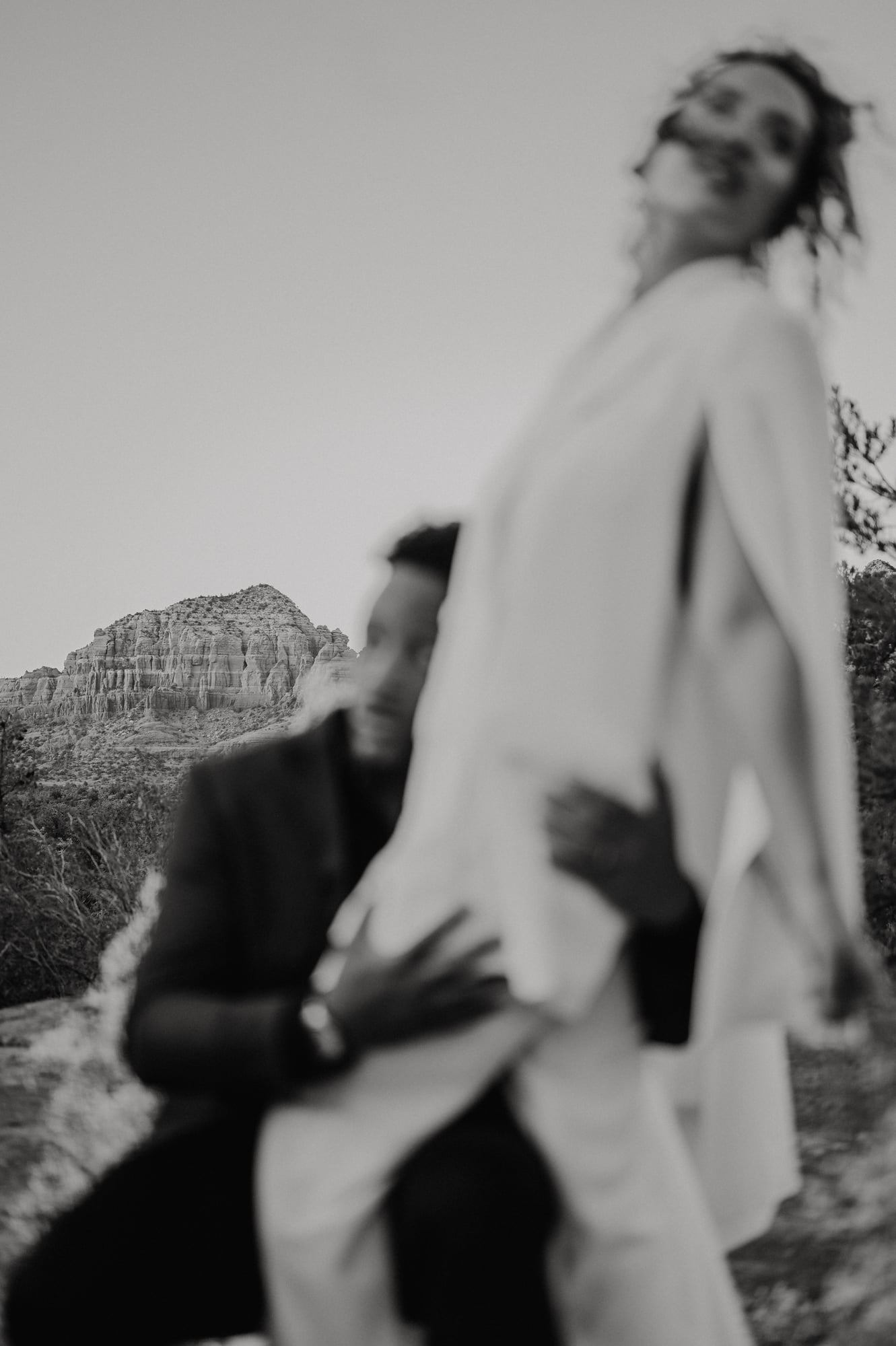 Softly blurred portrait of a couple embracing in the desert